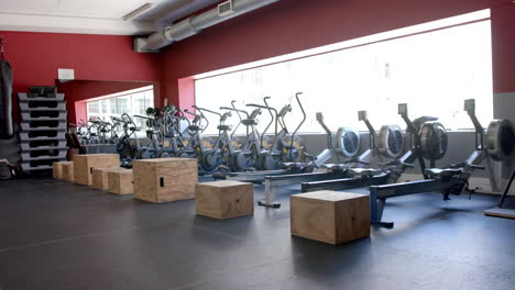 A-modern-gym-with-rows-of-stationary-bikes-and-rowing-machines