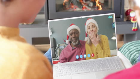 Happy-diverse-senio-couple-and-male-friends-having-christmas-laptop-video-call,-slow-motion