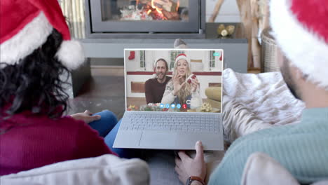 Two-happy-diverse-couples-having-christmas-laptop-video-call,-slow-motion