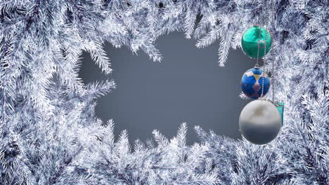 Animation-of-hanging-baubles-and-gift-box-over-snow-covered-leaves-against-gray-background