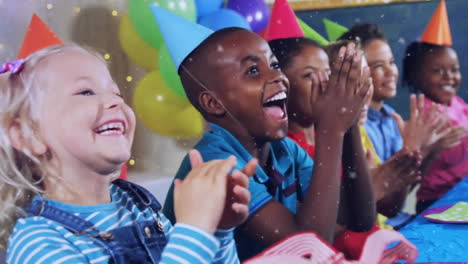 Animation-of-gold-confetti-falling-over-happy-diverse-children-clapping-at-birthday-party