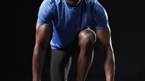 African-American-athlete-in-starting-position-on-a-black-background