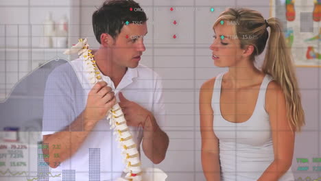 Animation-of-graphs-processing-data-over-caucasian-male-doctor-and-female-patient-studying-spine