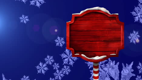 Animation-Eines-Roten-Holzschildes-über-Fallenden-Schneeflocken-Auf-Blauem-Hintergrund,-Kopierraum