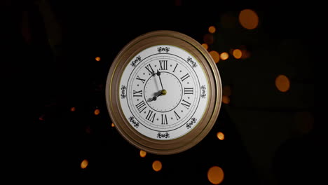 Animation-of-retro-clock-ticking-showing-midnight-with-spots-of-light-on-black-background