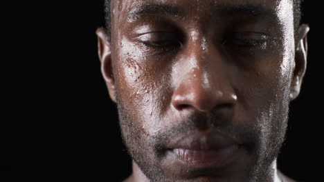 Nahaufnahme-Des-Schweißglänzenden-Gesichts-Eines-Afroamerikanischen-Sportlers-Auf-Schwarzem-Hintergrund