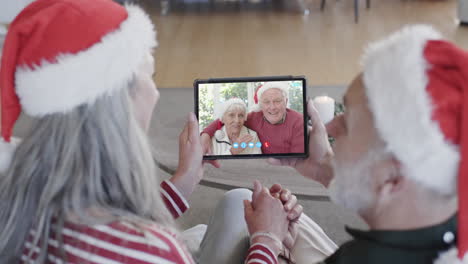Two-happy-caucasian-senior-couples-having-christmas-tablet-video-call,-slow-motion