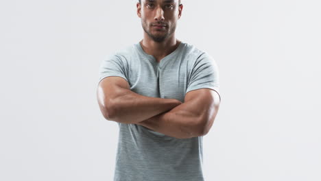 Young-biracial-athlete-man-poses-confidently-in-a-casual-setting-on-a-white-background