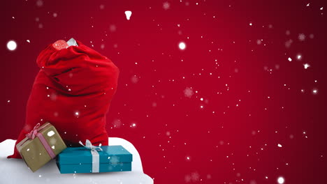 Animation-of-snow-falling-over-christmas-presents-with-copy-space-on-red-background