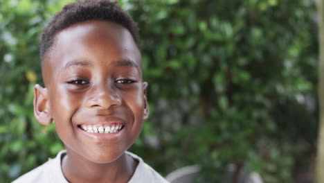 African-American-boy-smiles-brightly-outdoors-with-copy-space