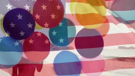 Animation-of-flag-of-usa-over-caucasian-woman-with-balloons-on-beach-in-summer