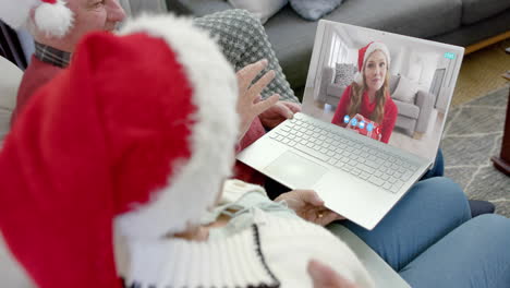 Happy-caucasian-senior-parents-and-daughter-having-christmas-laptop-video-call,-slow-motion