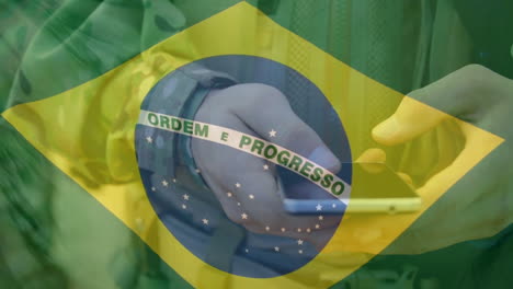 Animation-of-flag-of-brasil-over-caucasian-man-using-smartphone