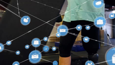 Animation-of-network-of-email-icons-over-caucasian-woman-with-prosthetic-leg-in-vr-headset-at-gym