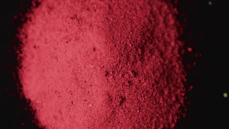 Video-of-close-up-of-red-powder-with-copy-space-on-black-background