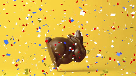 Animación-De-Confeti-Sobre-Conejo-De-Chocolate-Sobre-Fondo-Amarillo-En-Pascua
