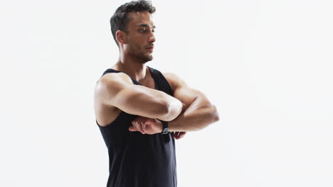 Young-biracial-athlete-man-stretches-before-a-workout-on-a-white-background,-with-copy-space