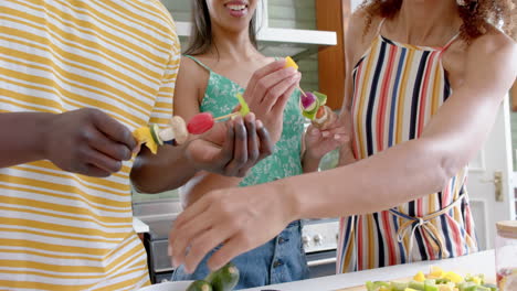 Diverse-group-enjoys-preparing-food-together-at-home
