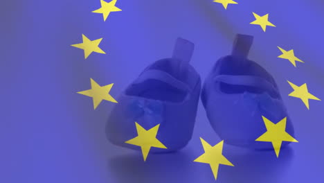 Animation-of-flag-of-eu-over-child-shoes