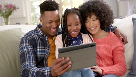 Portrait-of-happy-african-american-mother-with-daughter-using-tablet-at-home,-slow-motion