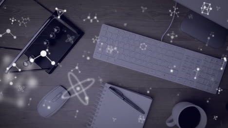 Animation-of-molecules-over-items-on-desk