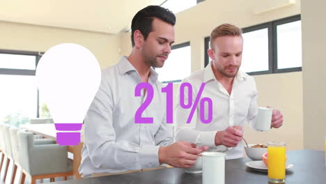 Animation-of-purple-light-bulb-and-percent-over-caucasian-gay-couple-having-breakfast-at-home