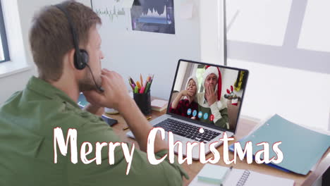 Animation-of-merry-christmas-text-over-diverse-couple-on-laptop-screen-at-christmas