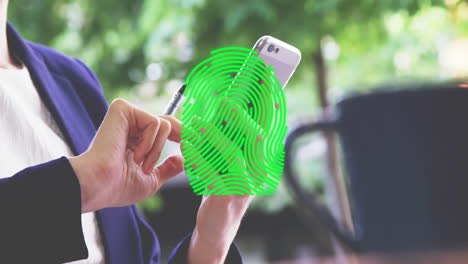 Animation-of-fingerprint-over-caucasian-businesswoman-using-smartphone