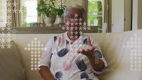 Animation-of-arrow-icons-over-senior-african-american-woman-talking-to-camera