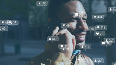 Animation-of-social-media-notifications-over-happy-african-american-man-talking-on-smartphone
