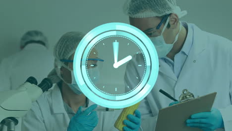 Animation-of-moving-clock-over-caucasian-male-and-female-scientist-in-lab