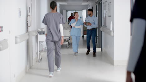 Healthcare-professionals-walk-through-hospital-corridors
