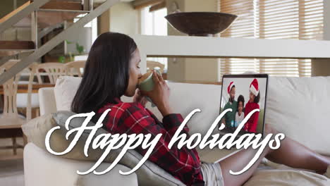 Animation-of-happy-holidays-text-over-african-american-family-on-laptop-screen-at-christmas