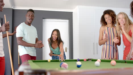 Diverse-group-enjoys-a-game-of-pool-at-home
