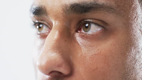 Close-up-of-a-young-biracial-man's-eyes-on-a-white-background