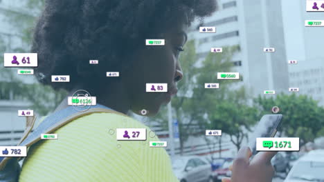 Animation-of-media-notifications-over-african-american-woman-using-smartphone-in-city-street