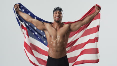 Athletic-biracial-athlete-swimmer-celebrates-victory-wrapped-in-the-American-flag