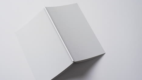 Video-of-book-with-white-blank-cover-pages-and-copy-space-on-white-background