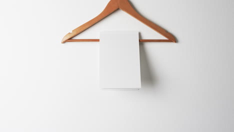 Video-of-book-on-hanger-with-white-blank-pages-and-copy-space-on-white-background