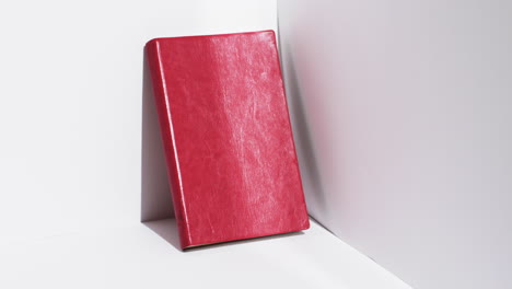 Video-of-book-in-red-cover-and-copy-space-on-white-background