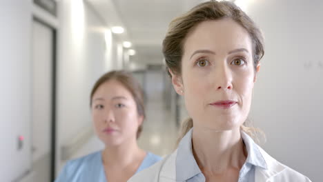 Portrait-of-diverse-female-doctors-standing-in-hospital-corridor,-selective-focus,-slow-motion