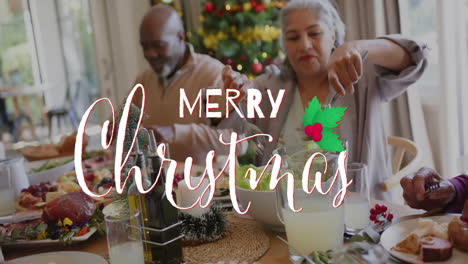 Animation-of-merry-christmas-text-over-diverse-senior-friends-at-christmas-dinner-at-home