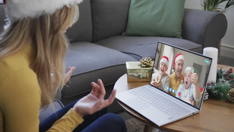 Caucasian-female-friend-and-father-with-sons-having-christmas-laptop-video-call,-slow-motion