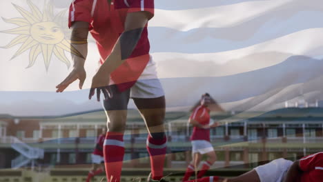 Animation-Der-Flagge-Uruguays-über-Verschiedenen-Männlichen-Rugbyspielern,-Die-Im-Stadion-Spielen