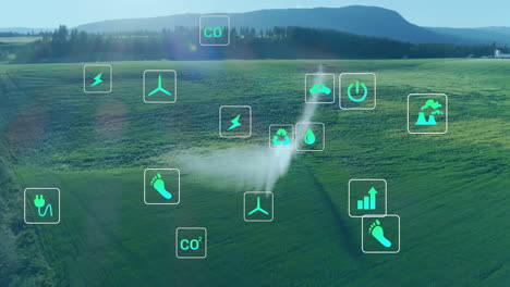 Animation-of-ecology-icons-over-landscape-with-water-sprinkler-on-field