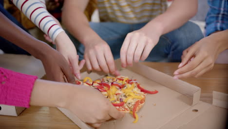 Diverse-group-of-teenage-friends-sitting-on-couch-and-sharing-pizza-at-home,-slow-motion