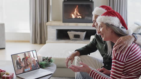 Happy-diverse-senior-couple-and-friends-having-christmas-laptop-video-call,-slow-motion