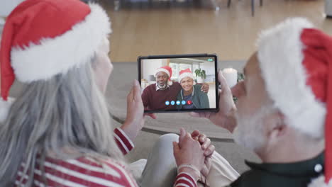 Two-happy-diverse-senior-couples-having-christmas-tablet-video-call,-slow-motion