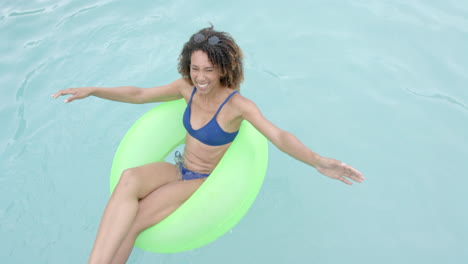 Biracial-woman-enjoys-a-sunny-day-in-the-pool