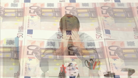 Animation-of-euro-banknotes-over-caucasian-man-using-laptop